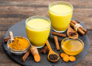 Turmeric golden milk latte with honey and cinnamon ayurvedic herbal certification