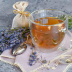 Fresh delicious tea with lavender and lavender flowers on gray stone table Perfect cup of tea