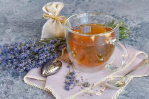 Fresh delicious tea with lavender and lavender flowers on gray stone table Perfect cup of tea