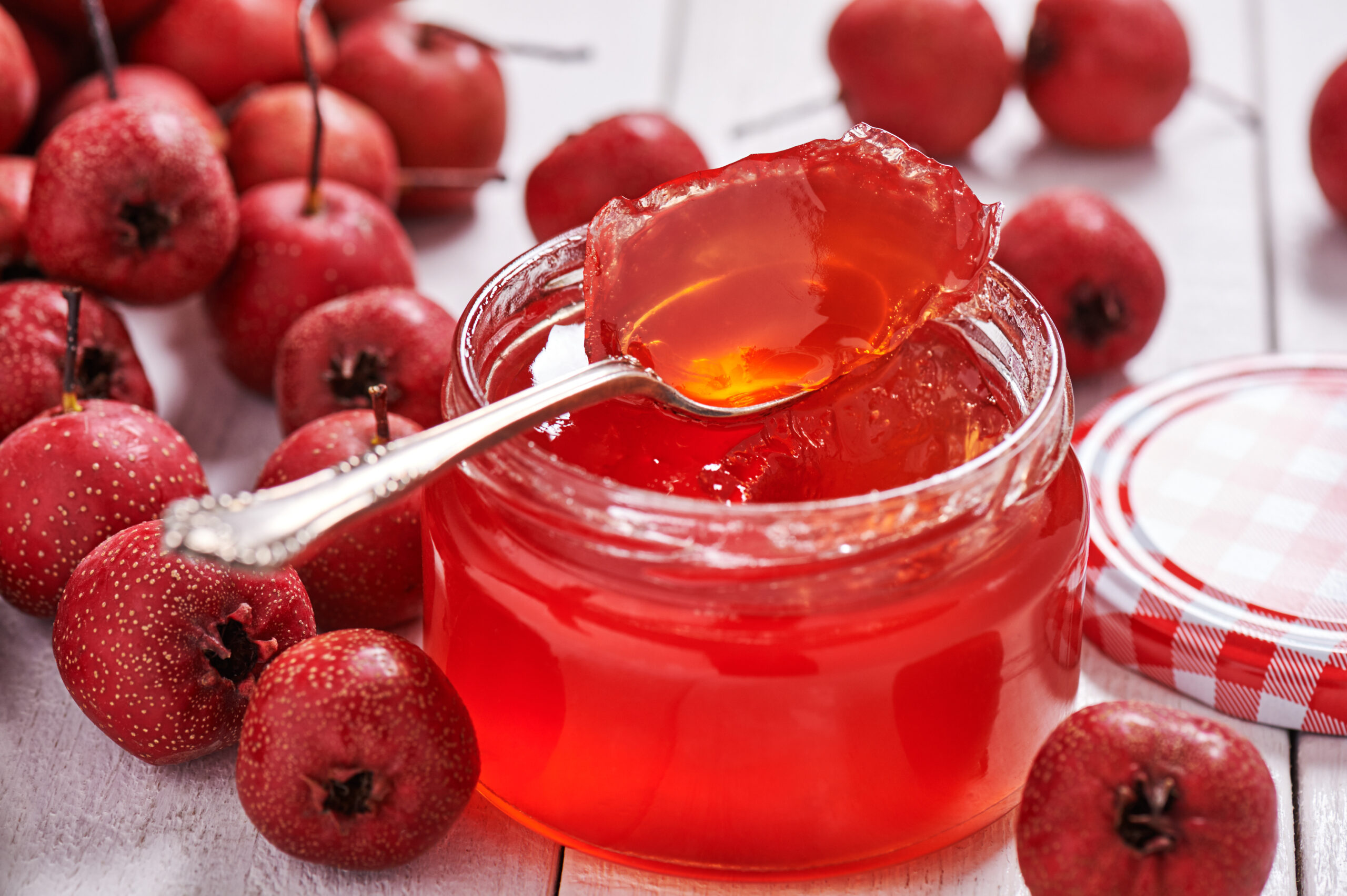 Jar with teaspoon hawthorn jelly hawthorn surrounded raw berries hawthorn